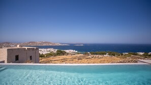 A clear blue sky, a swimming pool, and a view of the sea and distant buildings. - Mykonos Seabreeze Town Villa (Mykonos)