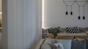 Un salon moderne avec un canapé, une table basse et un tapis à motifs.