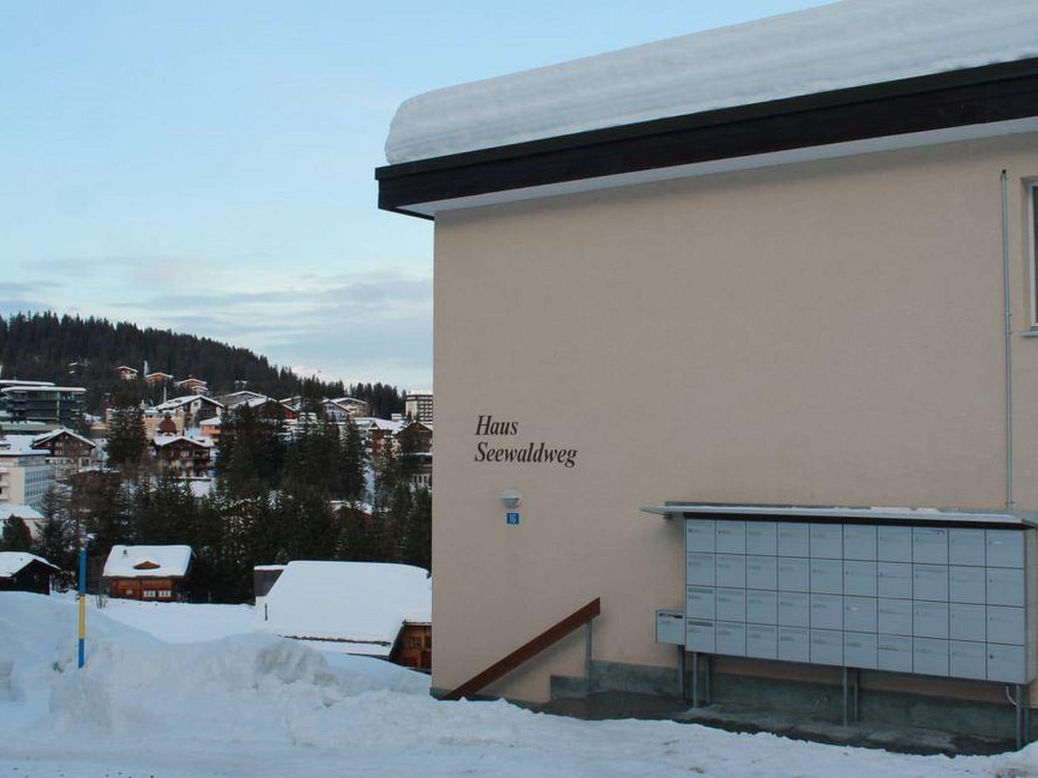 A building with a sign reading 'Haus Seewaldweg' and a mailbox.