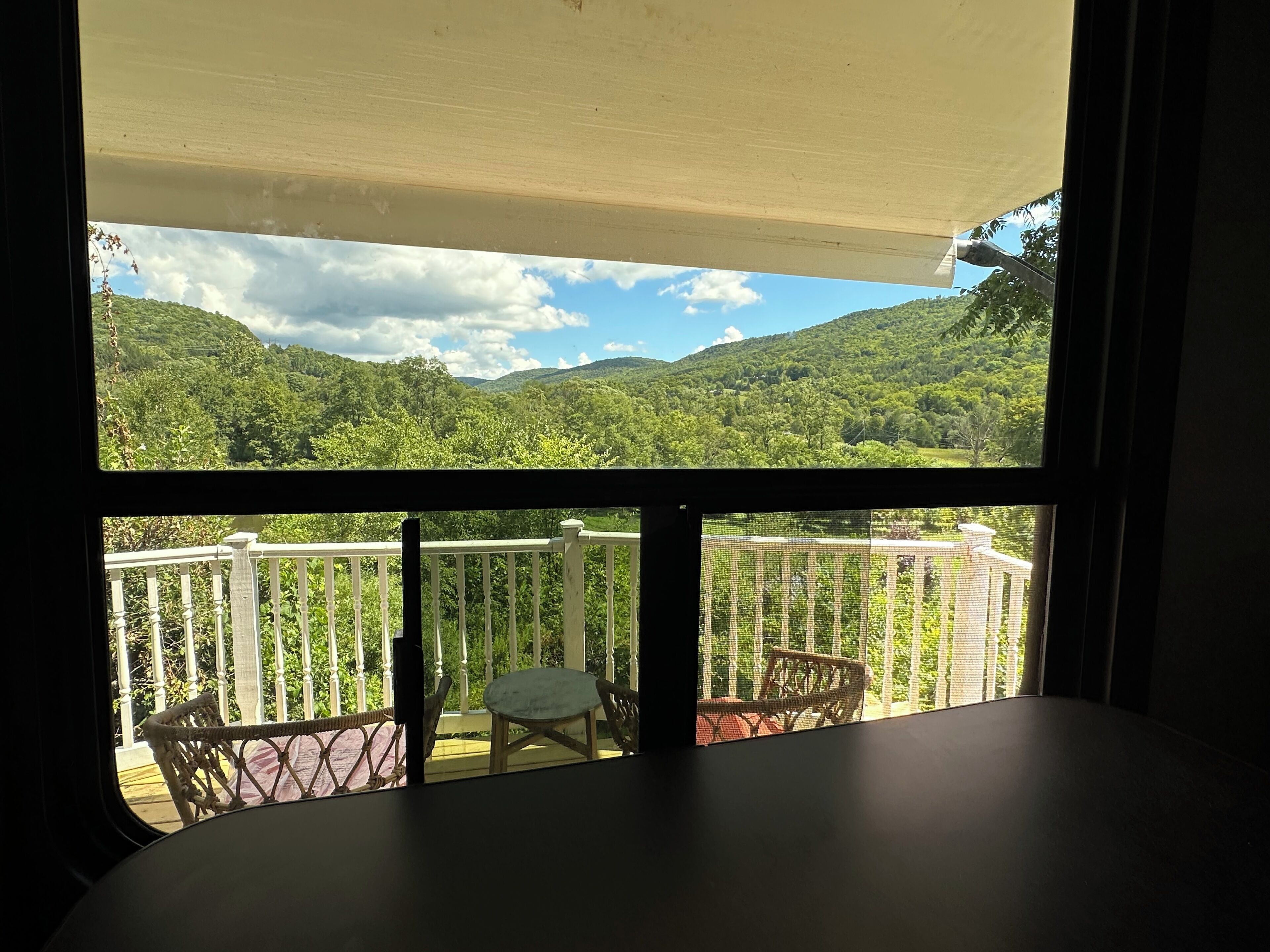 A balcony with a view of a mountainous landscape.
