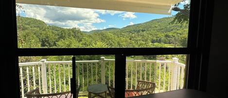 A balcony with a view of a mountainous landscape.