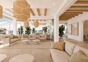 A spacious living area with a large sofa, two armchairs, a coffee table, and a dining area with a table and chairs. There are potted plants and a view of the ocean. - Villa Sirena – Seafront Boutique Hotel AO (Cala Figuera)