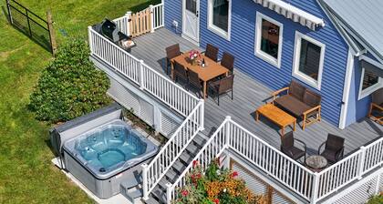 Relax at this pet-friendly Wine Trail retreat featuring a private hot tub, fire pit, spacious deck, and fenced yard. Minutes from wineries, breweries, waterfalls, scenic hikes, and Watkins Glen.