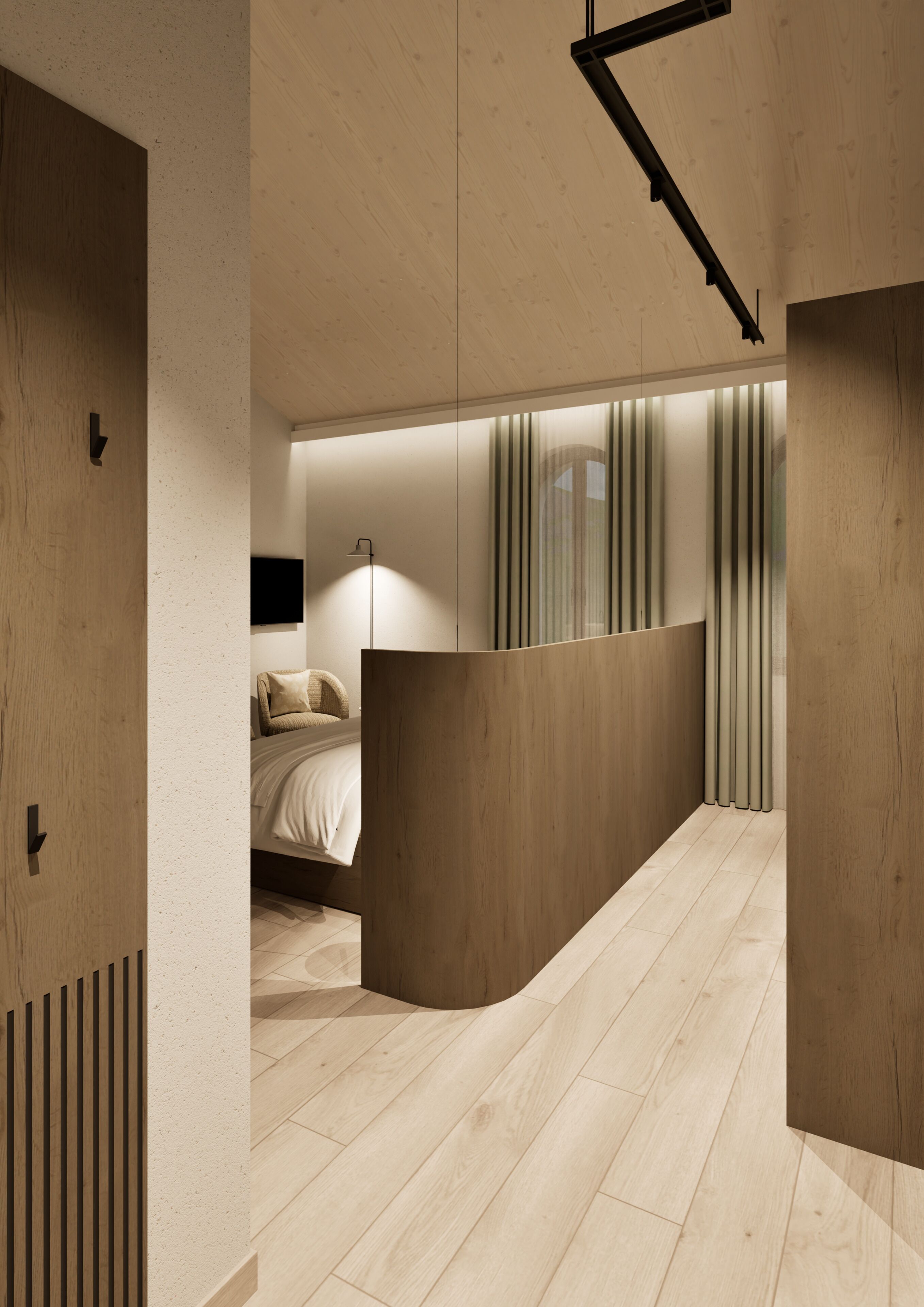 Ein modernes Interieur mit einer geschwungenen Trennwand, einem Bett mit weißer Bettwäsche, einer Stehlampe und einem an der Wand befestigten Fernseher.