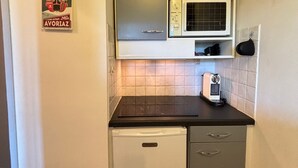 A compact kitchen with a microwave, a small refrigerator, and a coffee maker on the counter. - Comfortable apartment with south-facing balcony - 4 guests (Avoriaz)