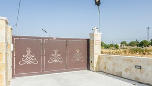 A gated entrance with decorative metal gates and a stone wall. - EmyHouse54 - Small Villa with Pool (Martina franca)