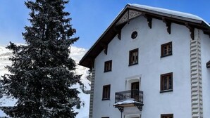 A multi-story building with a snow-covered balcony, surrounded by snow. - Roccabella Appartement/Fewo, Dusche oder Bad, WC, 2 Schlafräume by Interhome (Bivio)