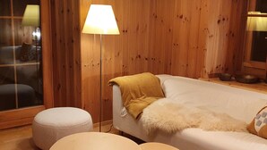 A cozy room with a bed, a lamp, and two small tables. - Roccabella Appartement/Fewo, Dusche oder Bad, WC, 2 Schlafräume by Interhome (Bivio)