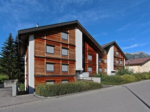 A modern multi-story building with a wooden facade and large windows. - Tgesa La Niva 11 Appartement/Fewo, Bad, WC, 2 Schlafräume by Interhome (Savognin)