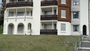 A multi-story residential building with balconies, a flat roof, and a front entrance with steps. - Casa Surselva Whg Bilger Appartement/Fewo, Bad, WC, 2 Schlafräume by Interhome (Savognin)