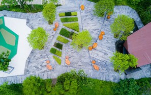 An aerial view of a landscaped area with pathways, trees, and hexagonal planters. - Noodle Nest..  Central Rama 9 - Comfortable Stay near MRT (Krung Thep Maha Nakhon)