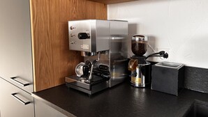 A modern kitchen with a built-in espresso machine and coffee grinder. - Bergnest 4 Appartement/Fewo, Bad, WC, 2 Schlafräume by Interhome (Bivio)