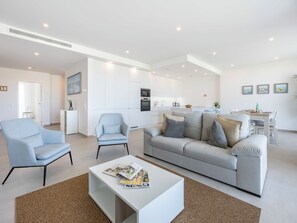 A modern living room with a sofa, armchairs, and a coffee table. - Lagos Odyssey - Sea Views and Dona Ana Bay (Lagos)