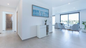 A modern living room with a large window, a white sofa, and a coffee table. - Lagos Odyssey - Sea Views and Dona Ana Bay (Lagos)