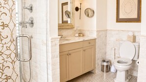 A bathroom with a shower, toilet, and vanity with a mirror. - Golden Pheasant Inn (Erwinna)