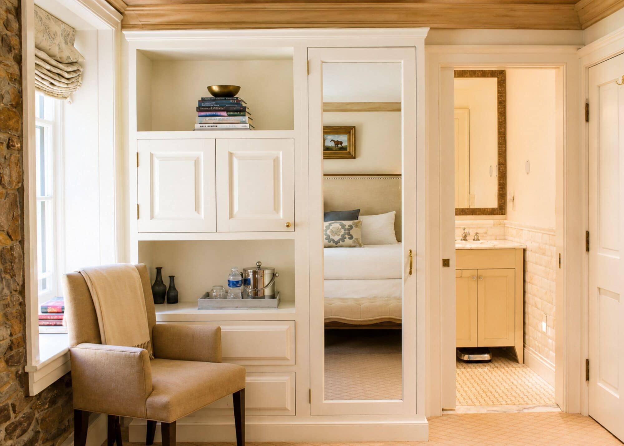 A bedroom with a bed, a bedside table, a chair, and a wardrobe.