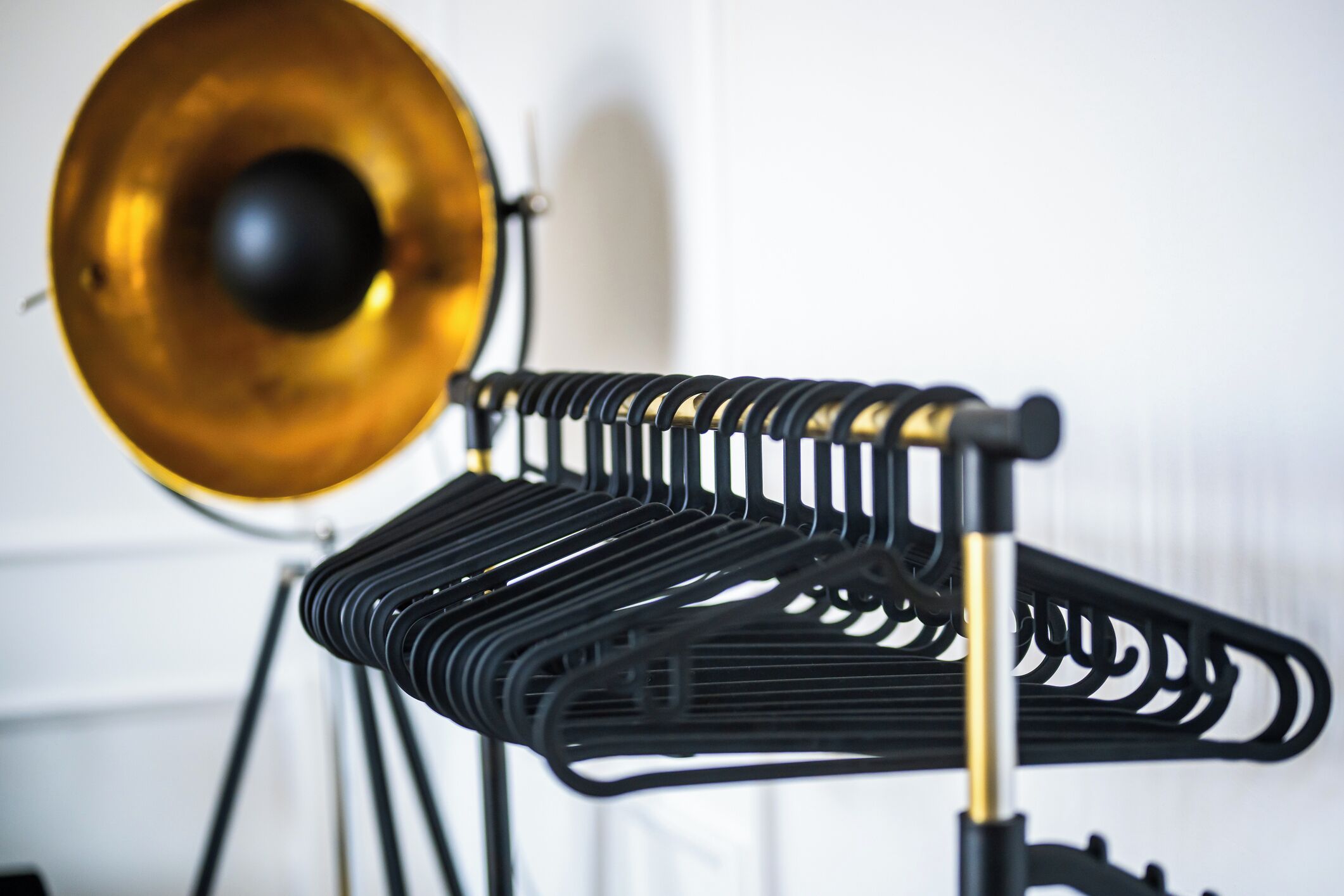 A black metal stand with a golden speaker and a black metal stand with a golden speaker.
