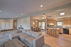 A spacious living area with a sectional sofa, a wooden coffee table, and a dining table with chairs. - 3-bedroom house in tranquil Cornwallville perfect for relaxing getaways (Cornwallville)