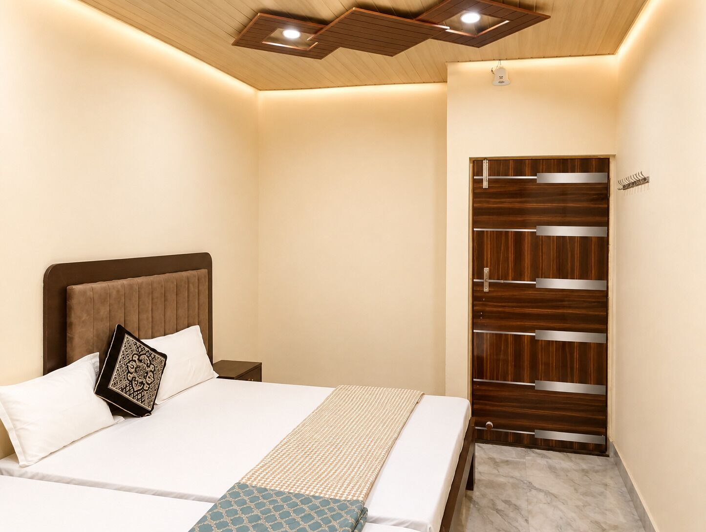 A bedroom with a bed, bedside tables, a wardrobe, and a ceiling light fixture.