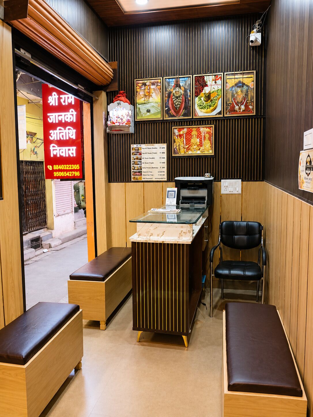 A restaurant interior with a counter, seating area, and wall decorations.