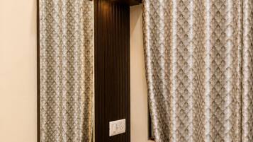 A bathroom with a mirror, a towel rack, and a shower curtain.