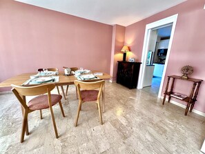 Ein Essbereich mit einem Holztisch, gedeckt für vier Personen, umgeben von Stühlen.