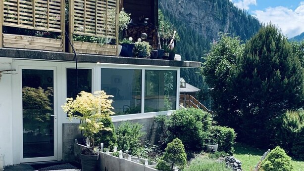 A modern house with a balcony, a garage, and a driveway. - Chalet Solana 1 # 2-bed apartment, Bad, WC 2-Bettwohnung, Bad, WC by Interhome (Leukerbad)