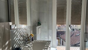 A bathroom with a large window, a sink, and a toilet. - Your Lake Como getaway (Casa Amata) (Cernobbio)