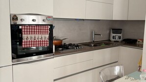 A kitchen with a stove, oven, and microwave. - Your Lake Como getaway (Casa Amata) (Cernobbio)