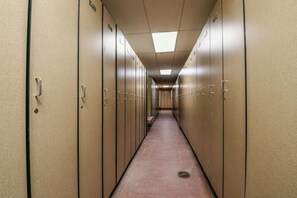 A long hallway with lockers on both sides and a bench in the center. - New Listing | King Bed | Steps from the slopes (Keystone)