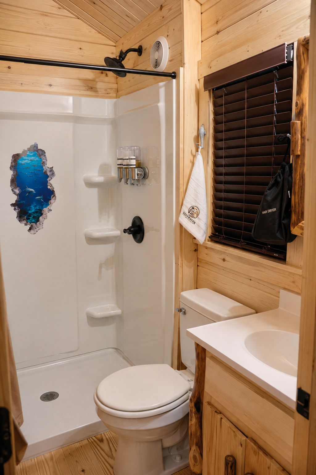 A small, compact bathroom with a shower, toilet, and sink.
