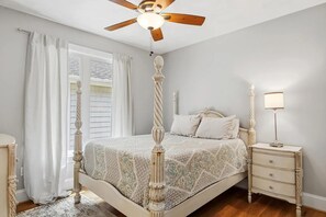 A bedroom with a four-poster bed, a nightstand with a lamp, and a ceiling fan. - Beautifully updated 5-bedroom, 4.5-bath home located at Blacksburg Country Club! (Blacksburg)