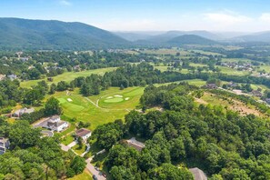 A golf course with multiple holes, surrounded by residential areas and dense forests. - Beautifully updated 5-bedroom, 4.5-bath home located at Blacksburg Country Club! (Blacksburg)