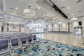 A conference room with rows of chairs, a patterned carpet, and a chandelier. - Furnished cozy 2-bedroom/2-bathroom condo 
in the resort-style gated community. (Boynton Beach)