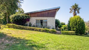 A modern house with a stone facade, large windows, and a sloped roof. - Villa with Large Garden and Pool (La Cavada)