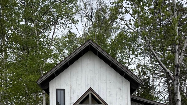 A small, single-story building with a gabled roof and a front door.