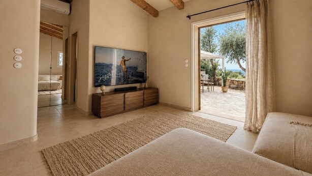 A bedroom with a large bed, a TV mounted on the wall, and a view of an outdoor patio. - Casa di Luce - Hot tub & beach within walking distance, ocean view (Corbara)