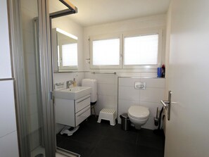 A bathroom with a toilet, sink, and shower area. - Perrine 1 Appartement/Fewo Appartement/Fewo by Interhome (Saas-Fee)