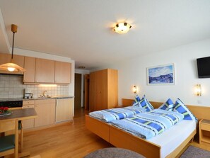 A compact room with a bed, a small kitchenette, and a television. - Haus Orion Appartement/Fewo 2-Bettwohnung Nr. 7 by Interhome (Saas-Fee)