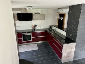 A modern kitchen with a built-in oven, a sink, and a countertop. - Alouette Appartement/Fewo Apartment Lama by Interhome (Saas-Almagell)