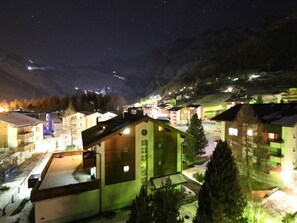 A nighttime view of a village with buildings and a mountain backdrop. - Sarazena Appartement/Fewo 2-Bettwohnung X by Interhome (Saas-Fee)