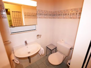 A compact bathroom with a sink, toilet, and a small stool. - Sarazena Appartement/Fewo 2-Bettwohnung X by Interhome (Saas-Fee)