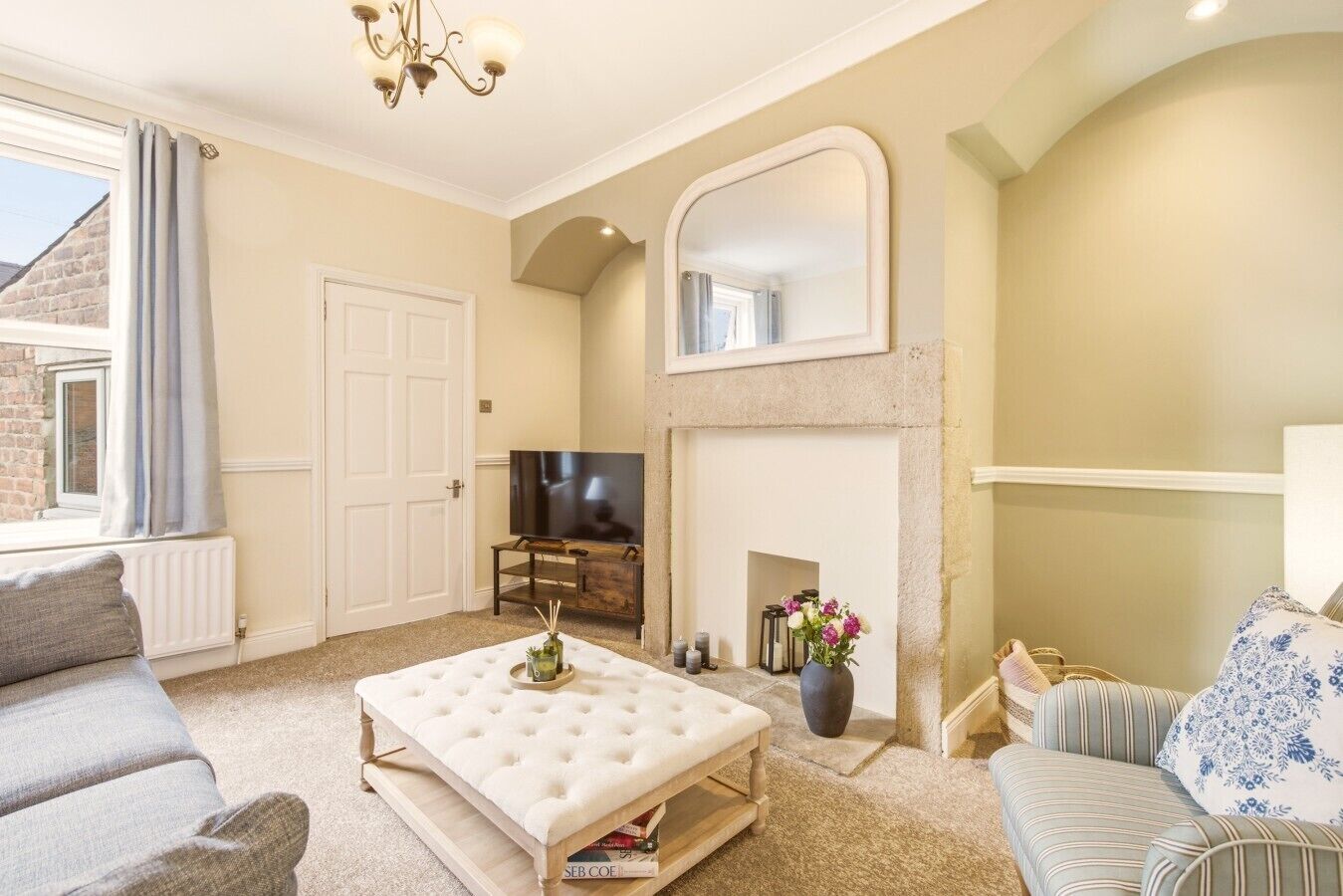 A living room with a fireplace, a television, and a sofa.