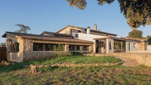 A stone house with a tiled roof, a large window, and a door. - La Sardagne | Charming House in the Heart of the Garrigue, Near Vallon-Pont-d'Arc (Bourg-Saint-Andéol)