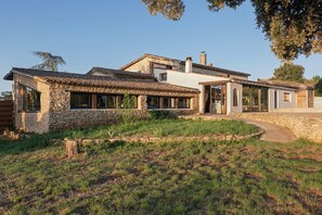 A stone house with a tiled roof, a large window, and a door. - La Sardagne | Charming House in the Heart of the Garrigue, Near Vallon-Pont-d'Arc (Bourg-Saint-Andéol)