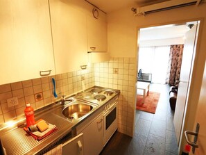 A compact kitchen with a stove, sink, and cabinets. - Sarazena Appartement/Fewo 2-Bettwohnung T by Interhome (Saas-Fee)