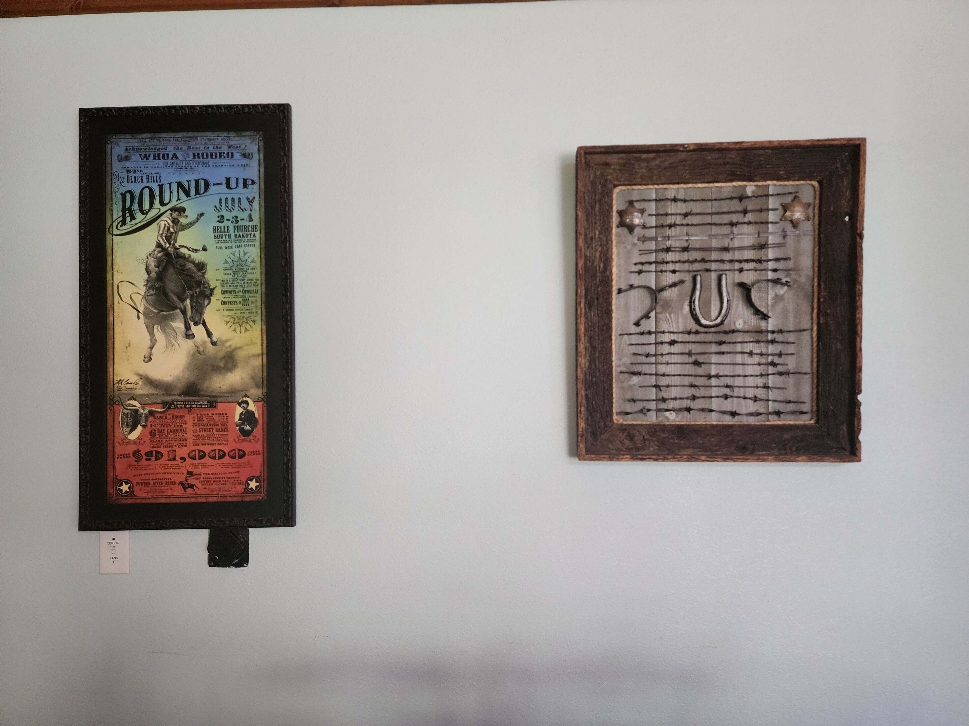 Two framed items on a wall: a vintage rodeo poster and a framed piece with a horse silhouette and text.