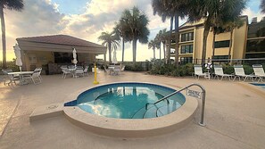 A swimming pool with lounge chairs and a covered seating area. - BEACHFRONT! Beautiful pool, hot tub, tennis, pickle &LOTS of restaurants nearby! (St. Augustine)