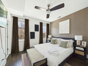 A bedroom with a bed, bedside tables, a ceiling fan, and a window with curtains. - Peaceful Boho Retreat | Free Private Parking (Chicago)