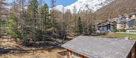 Un chalet doté d’une terrasse en bois et d’une enseigne indiquant « Chalet Steinbock ».